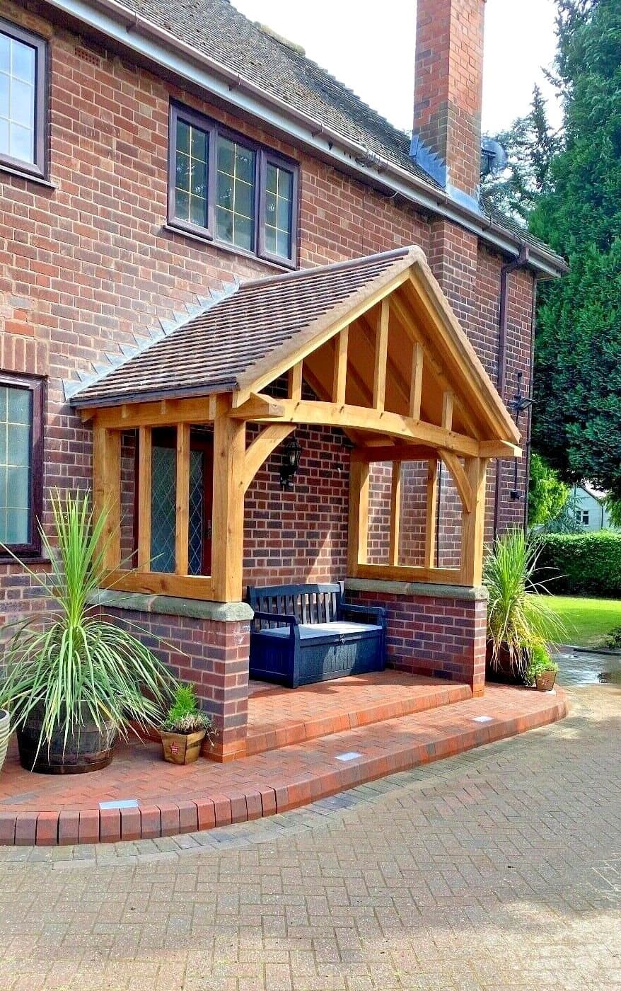The Stroud oak porch from the side, showing its depth and side screens over brick dwarf walls