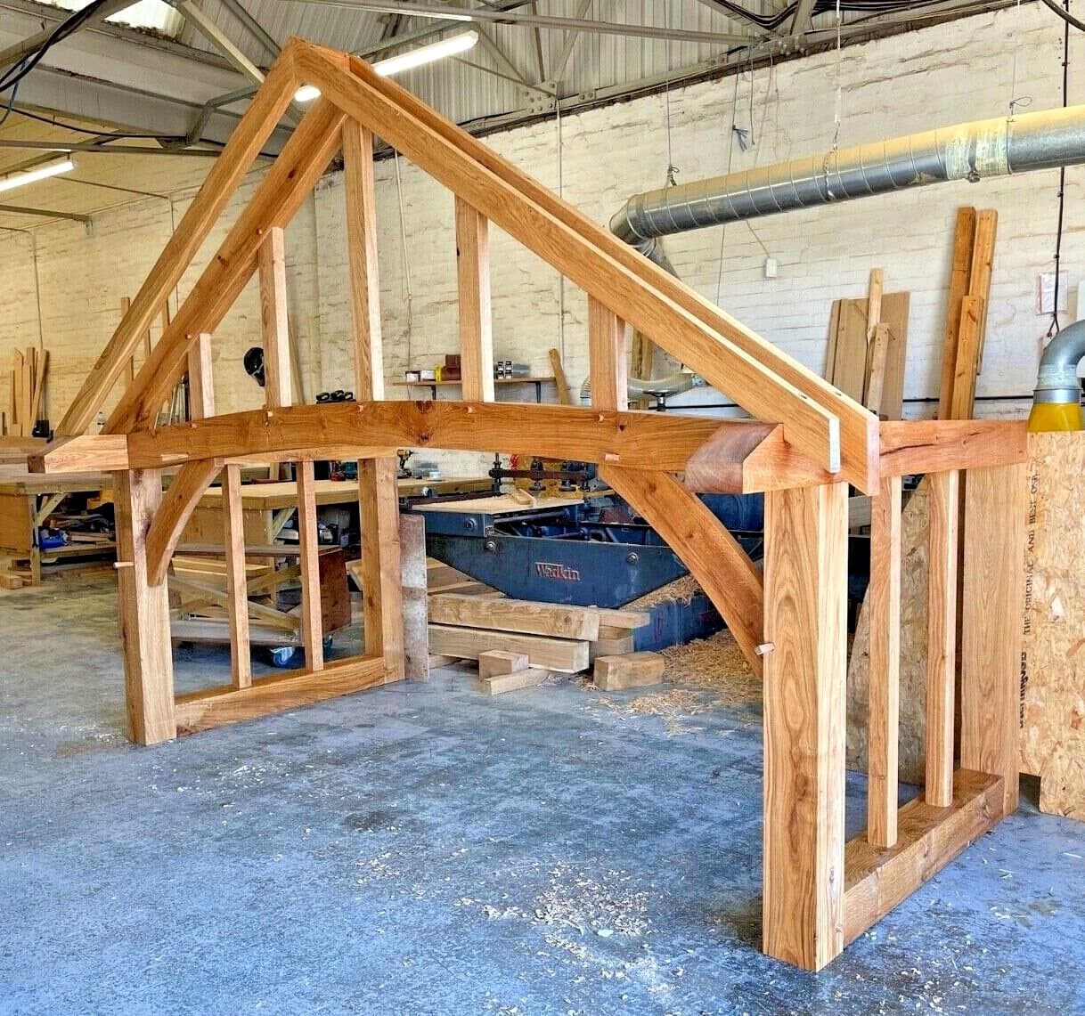 Stroud porch frame in build — curved beam, gable uprights and braces test-fitted