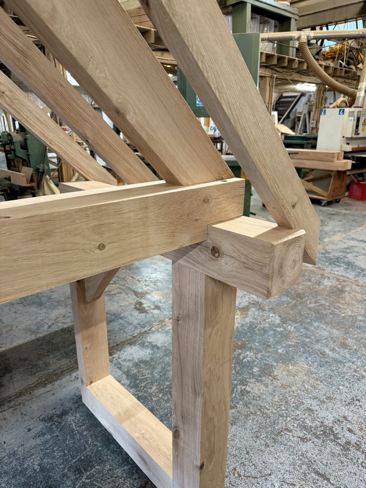 An oak porch frame dry-fitted beside the planer in our Worcestershire workshop