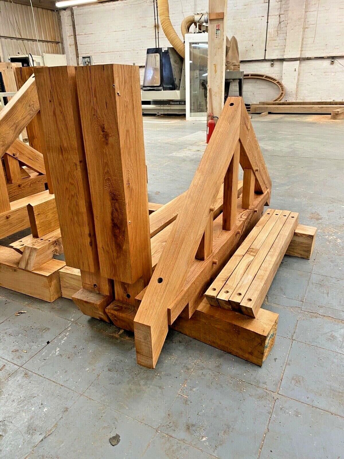A porch frame taken apart and stacked as a numbered kit, ready for delivery